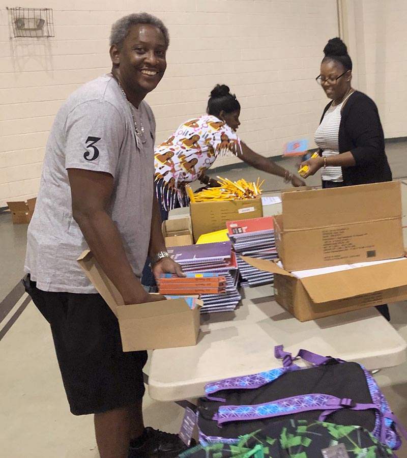 NJ Alumni Services Director Arthur Townes (L) and reentry alumna Dorothy B. volunteer to pack donated school supplies for families in NJ.